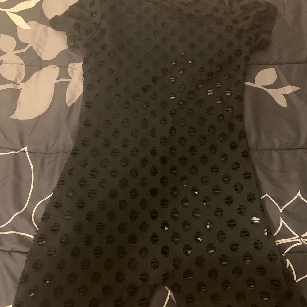 Black one piece with holes . Worn. Once